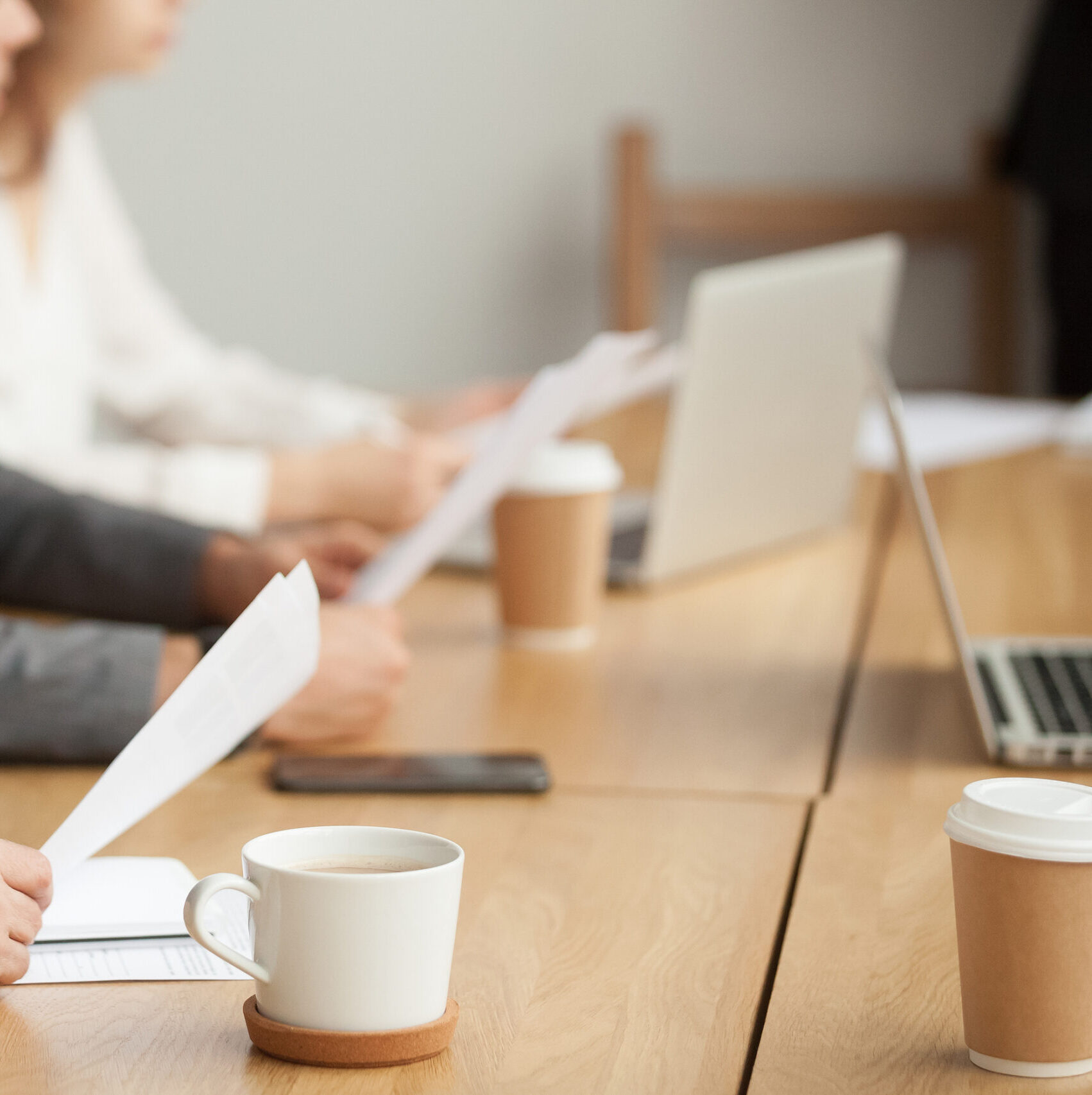 Attentive Senior Businessman Holding Documents Focused On Listen